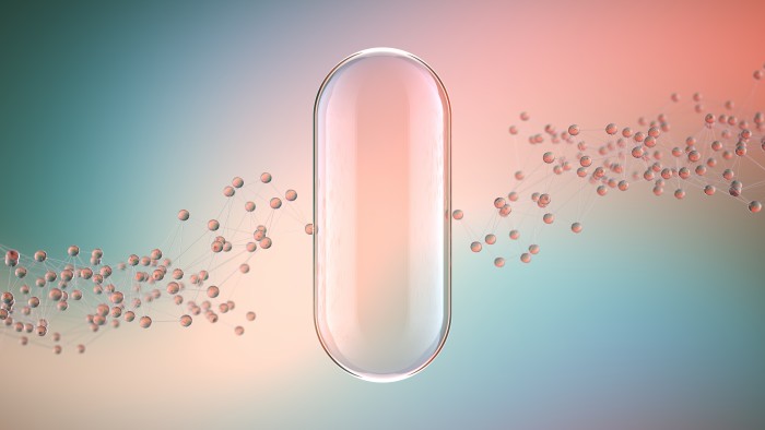 Outline of a capsule pill against a pink and blue background with bubbles floating around it 